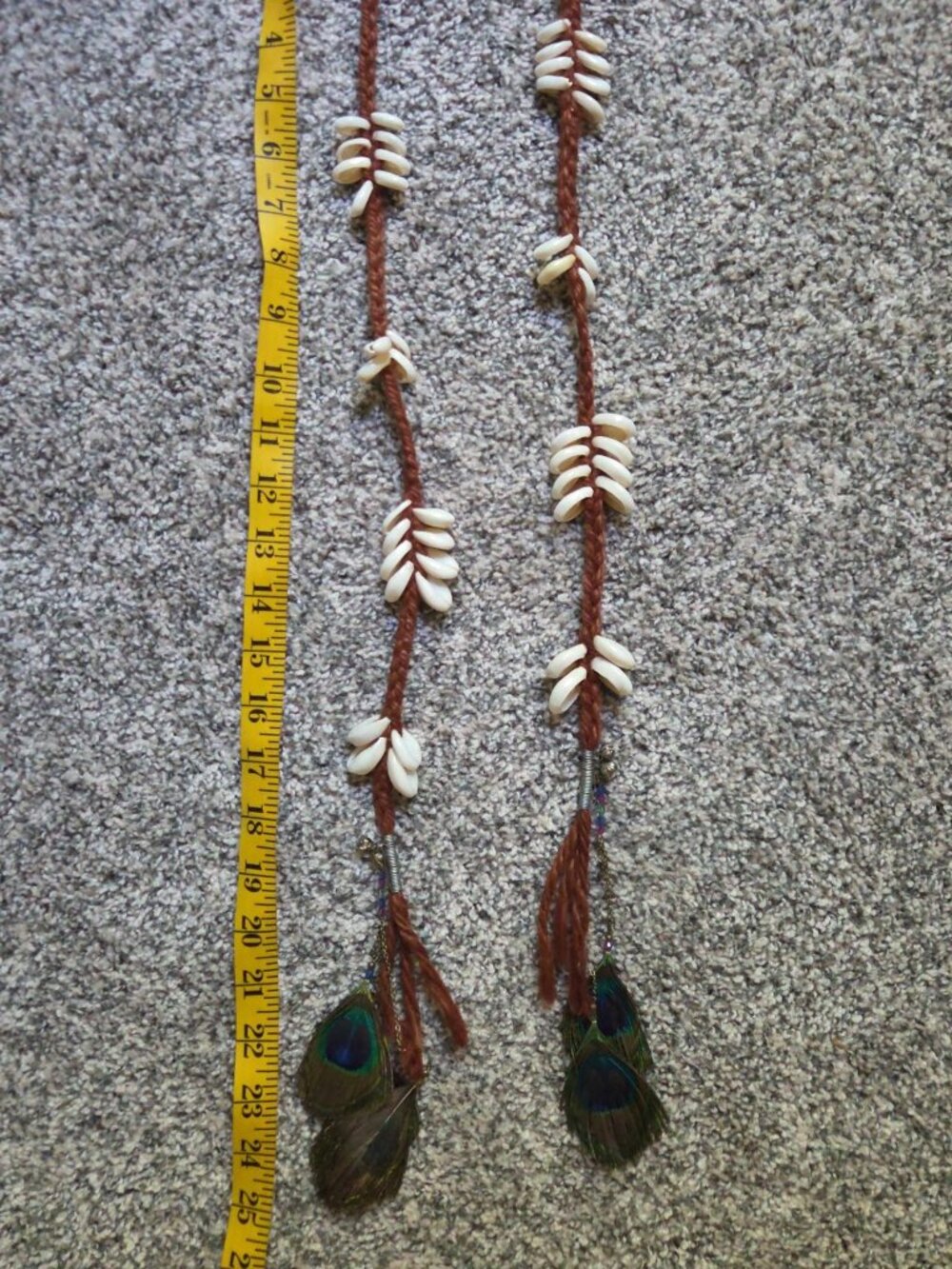 Handmade boho cowry shell hair falls featuring brown braided cord and peacock fe